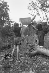 Bettie H_ and Anita putting up camp sign