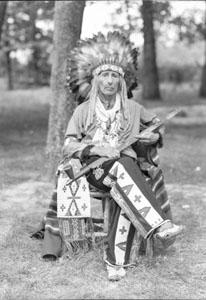 Chief Eagle-Feather sitting in chair 