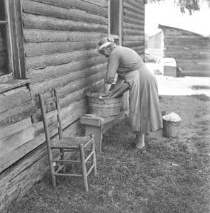 Country woman washing beside house - clothes - Aunt Minnie