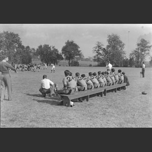 Foot-ball players seated on bench during game T.I.S. - Bench warmers
